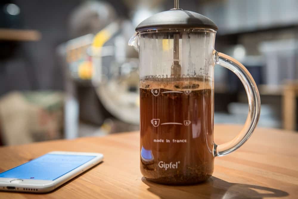 How to make French Press Coffee - Step 5: Add more water - CoffeeHow.co