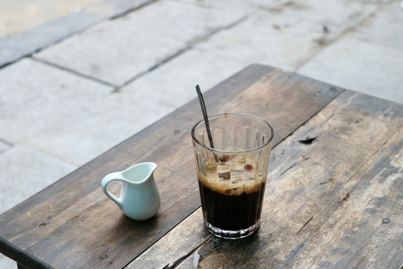 Vietnamese black iced coffee (cà phê đen đá) with a small milk jug