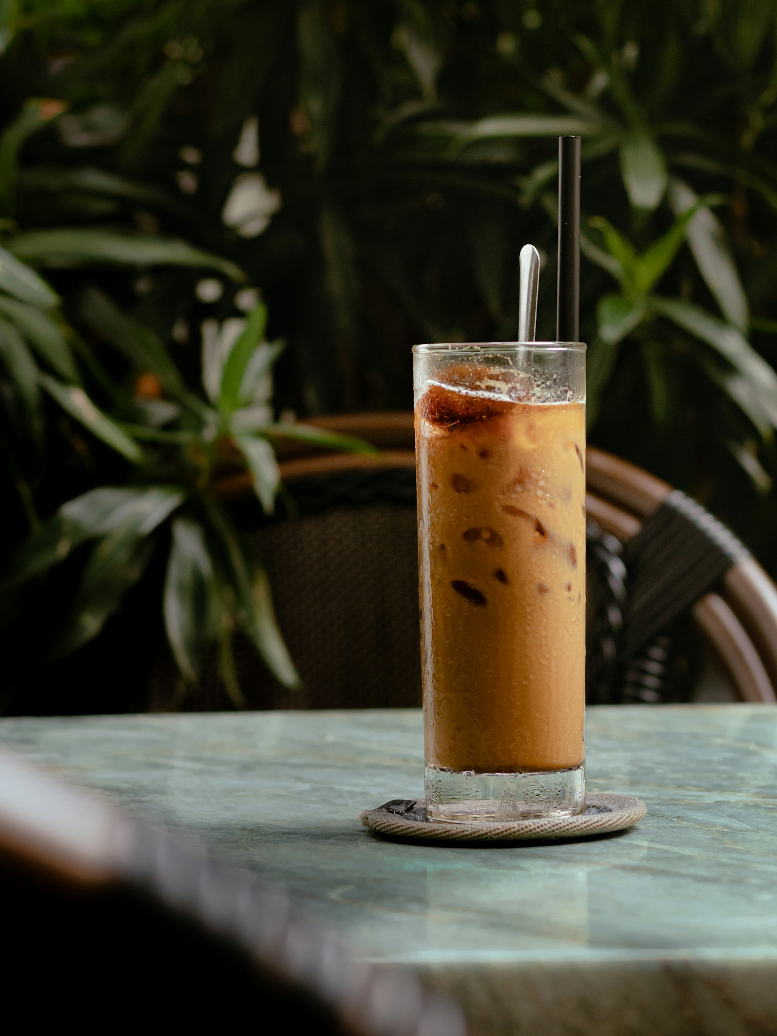 A tall glass of Vietnamese iced coffee with condensed milk (cà phê sữa đá)