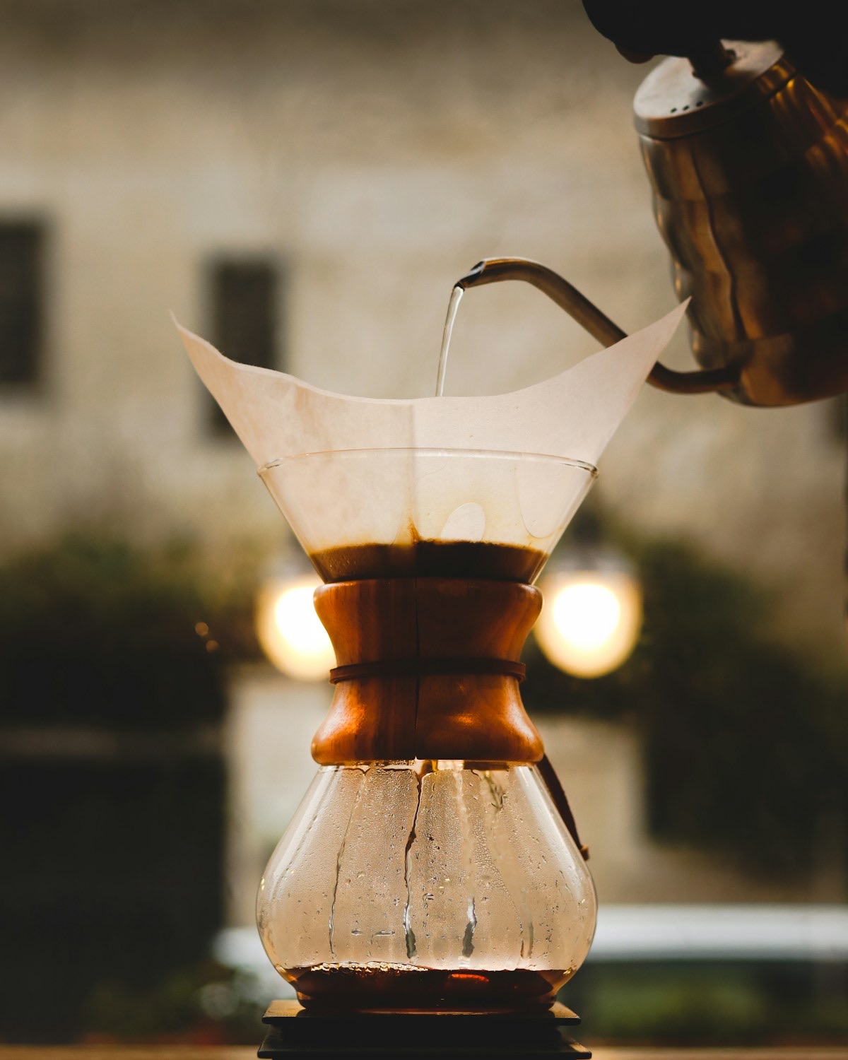 Pouring hot water from a gooseneck kettle into a Chemex