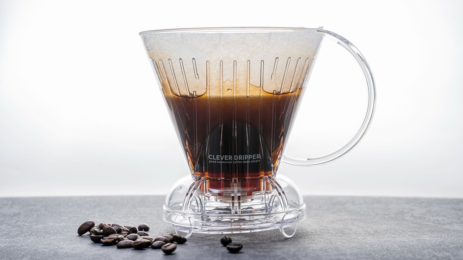 A Clever Dripper steeping coffee, with the brewed coffee visible through the clear plastic cone