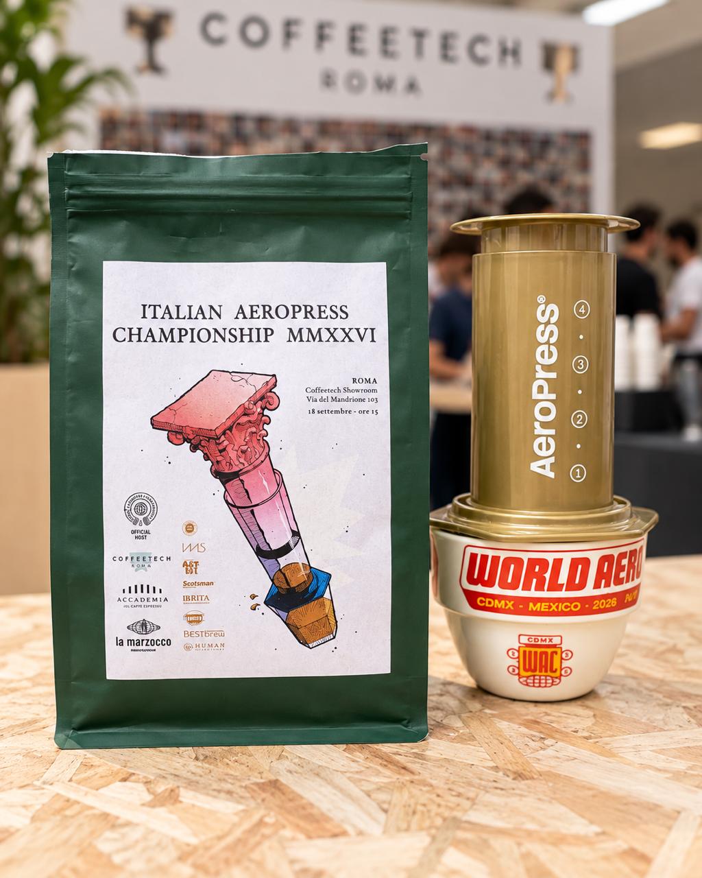 Bag of Italian AeroPress Championship 2026 coffee next to a gold AeroPress on a World AeroPress Championship Mexico 2026 cup