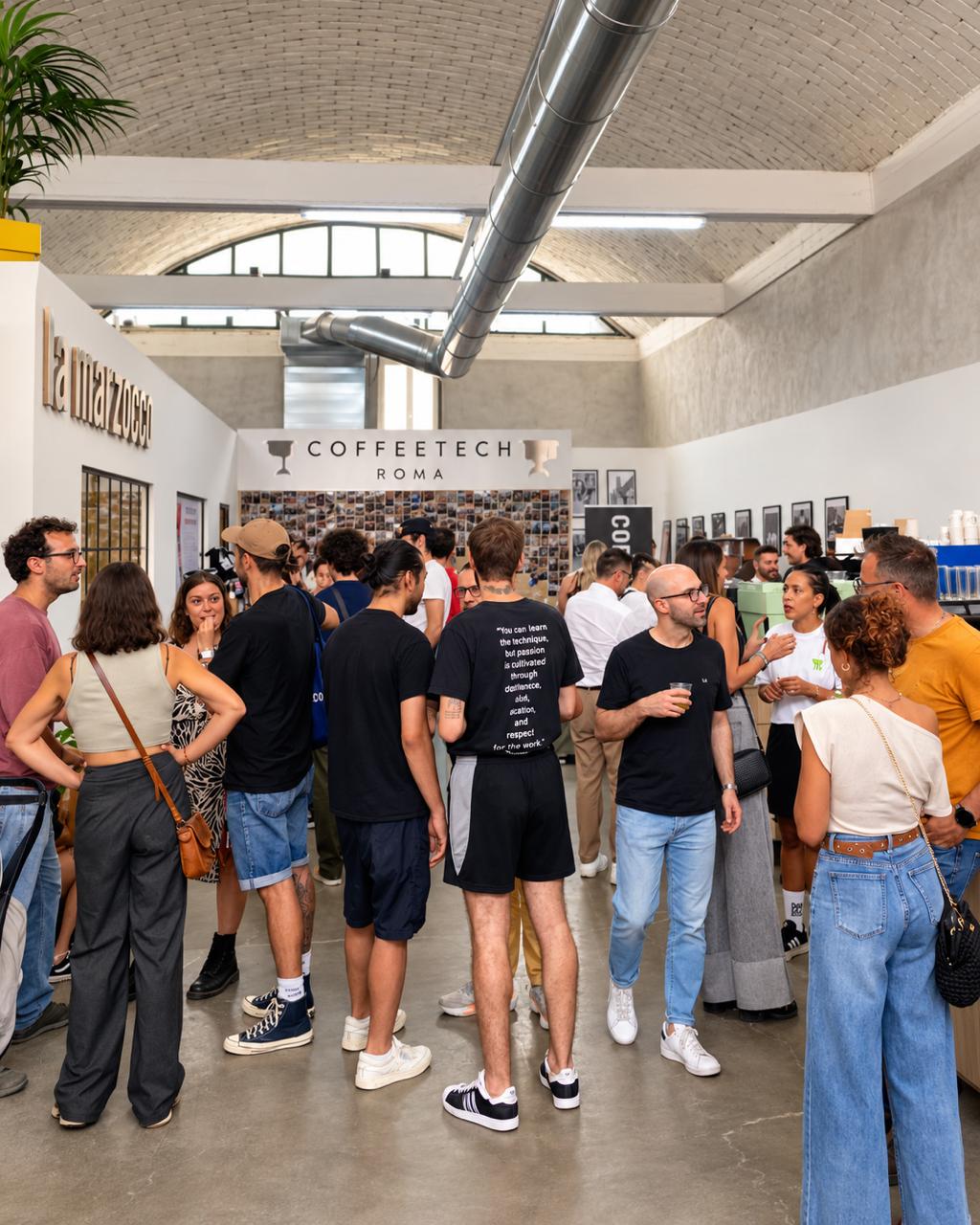 Crowd of baristas and guests at Coffee Tech in Rome during the Italian AeroPress Championship 2026, under a vaulted brick ceiling