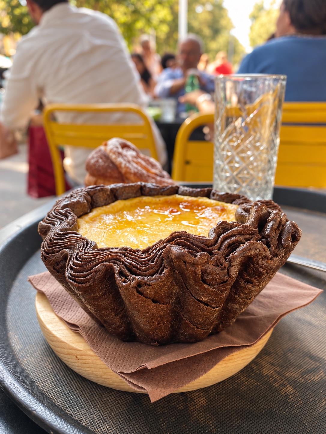 Nero Vaniglia's flan parisien: yellow custard with a caramelized top in a tall, ruffled cocoa croissant crust