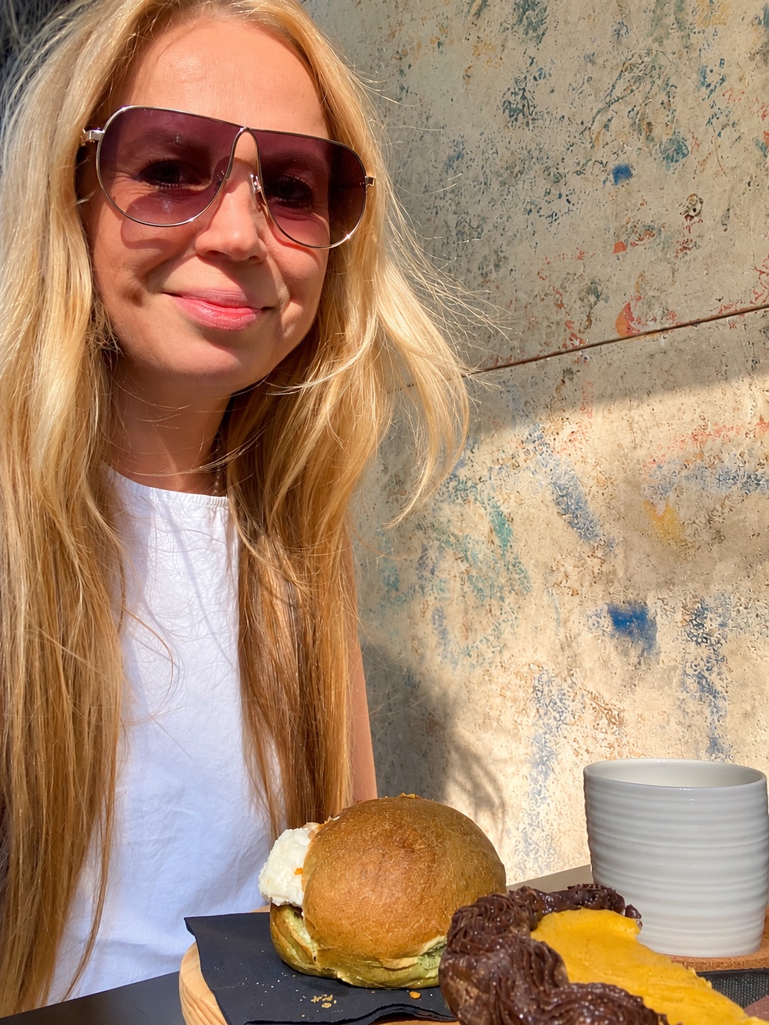 Sasha Pavlovich on Nero Vaniglia's terrace with a spinach bauletto, flan parisien and filter coffee