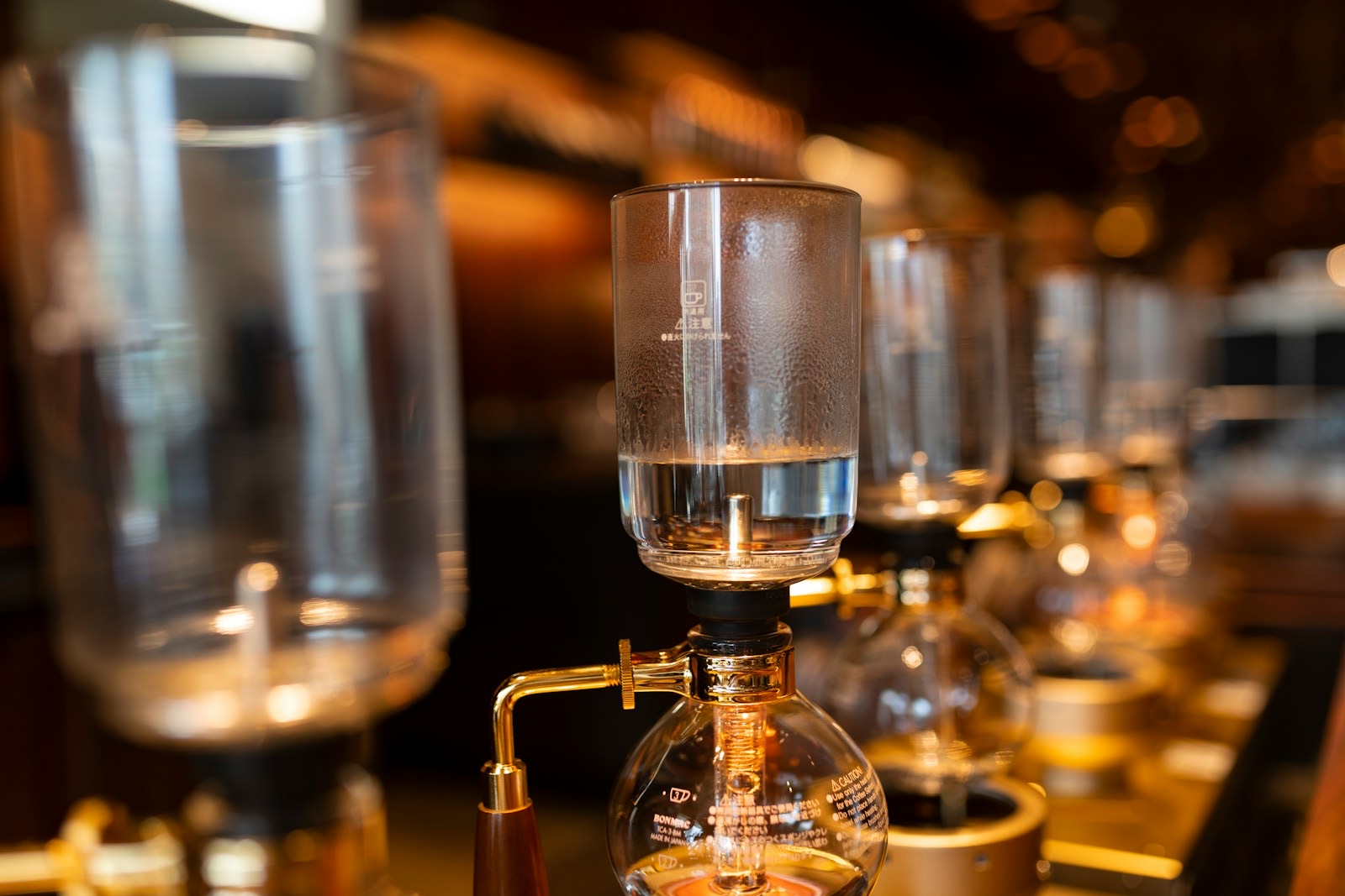 Hot water risen into the upper chamber of a siphon coffee maker