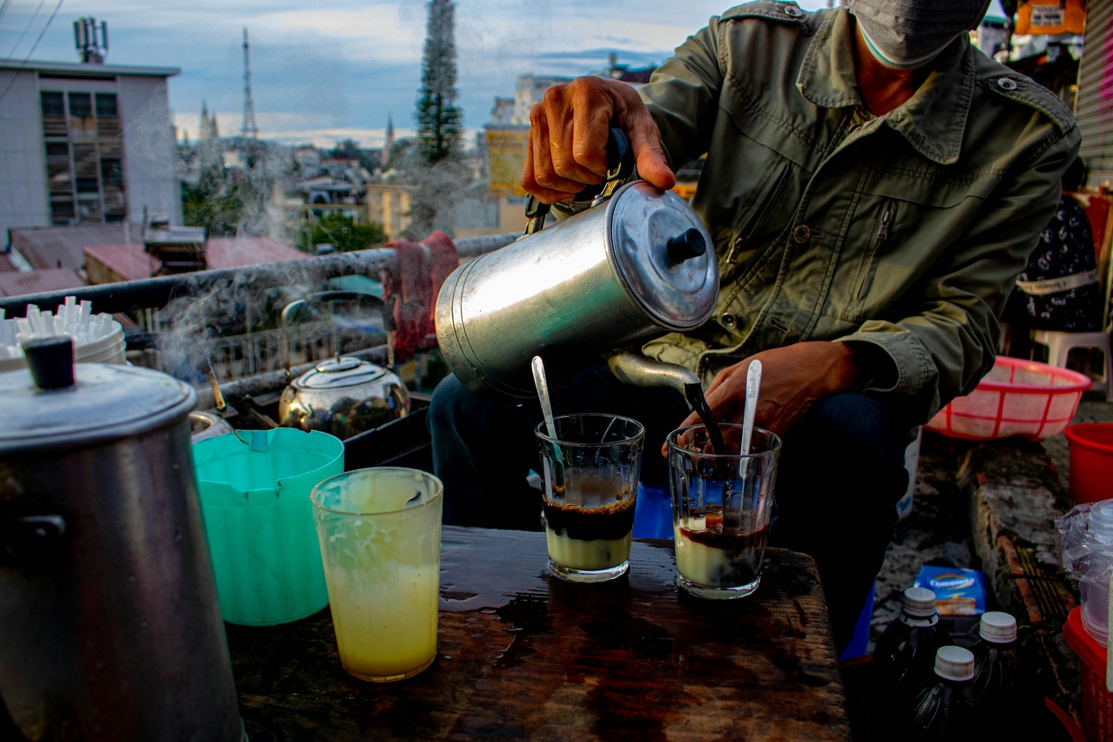 A street vendor pouring hot water for coffee in Da Lat, Vietnam